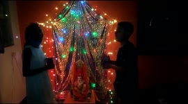 Small kids celibrate Ganesh Chaturthi festival inside house in India.