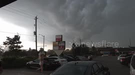 Thunderstorm and heavy rain doesn't stop intrepid food delivery courier in Waterloo Canada from heading out to deliver to a customer on his motorbike