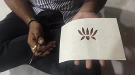 Stencil art: Talented artist creates lotus flower shape with paper and scissors