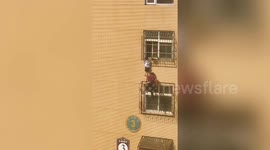 Chinese worker climbs 4 floors to rescue boy hanging from window