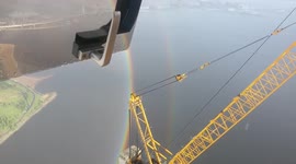 Amazing! Wide-angle view of beautiful rainbow from top of construction crane in Russia