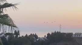 Airplanes fly over Estepona and try to extinguish the fire. Estepona, Spain