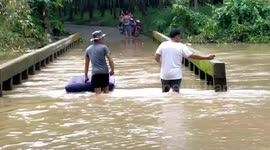 Bridge flooded after continuous rainfall overflows canal in southern Thailand