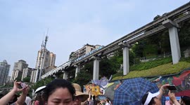 Tourists Amazed By Light Rail Crossing Building In Chongqing, China