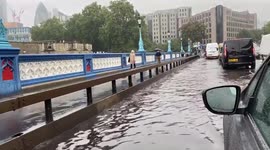 Dramatic footage shows Tower Bridge in London flooded after torrential rain