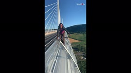 Skater pulls of crazy BASE jump off bridge in France