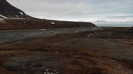 Spitsbergen in spring. Drone view, sea view, glacier, snow, small hut in the background