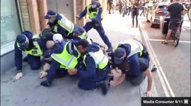 Protester left with bloody head after police pile on protesters at anti-vaccine rally in London