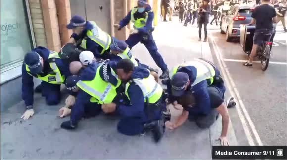 Protester left with bloody head after police pile on protesters at anti-vaccine rally in London