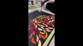 Aboriginal artist paints bush medicine leaves with one flick of the brush