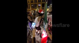 Energetic dancing and a lantern man on stilts with flags in Chicago, IL, USA