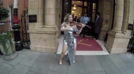 A Violinist Shows Of her Skills Outside The London Fashion Week Icon Party