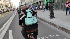 Dog in a backpack beared by his master on a bicycle. Paris. Rue de Rivoli.19sept2021