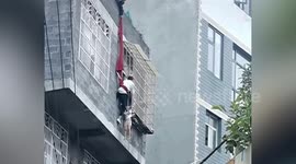 Neighbours rescue girl hanging from third-floor window in China
