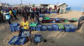Palestinian fishermen work on the shore of the Mediterranean Sea