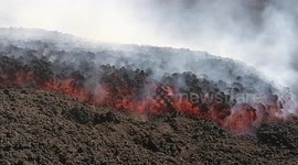 Stunning closeup of molten lava flowing down flanks of Mount Etna after latest eruption