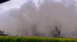 Huge waves whipped up by strong winds crash down on passing cars in China