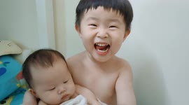 Precious moment of a three years old brother hugs his newborn sister