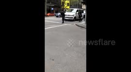 A guy runs through a protest after the earthquake in Melbourne, Australia