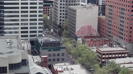 People run away from police during a protest in Melbourne, Australia