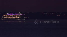 Disney Magic cruise ship looks spectacular illuminated at night off Kent, UK