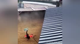 Sanitation worker avoids being buried by sand after transport truck tips over in China