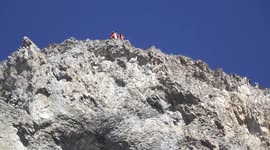 Three daredevil wingsuit flyers basejump off peak in Alps