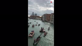 'Venice, Italy: Quartet of musicians perform on a violin-shaped boat'
