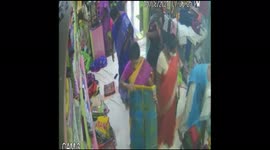 Woman thieves tuck clothes under saree
