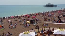 UK hottest day Brighton crowded beach promenade