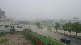 People swim in deep floodwater in Pakistan