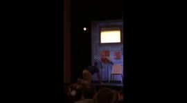 Moron jumps on stage on Broadway to try and charge his phone in a fake outlet