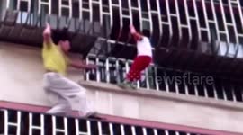 Man rescues boy dangling from balcony