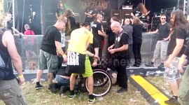 Crowd helps metal fan in wheelchair after moshpit fall
