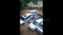 Flash floods sweep cars into river