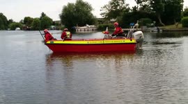 Rescue boat searches with sonar for missing swimmer on the Thames
