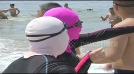 Beachgoers wear 'facekinis' in summery China