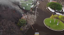 Drone footage - La Palma Volcano 22/09/2021. Lava devouring a green building. Drone really close to the lava.