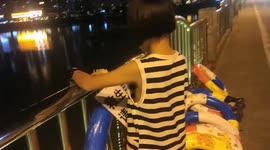 Mother and daughter tie lifebuoys to bridges in order to help rescue more locals