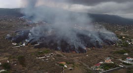 Smoke rises as lava engulfs buildings and trees in La Palma