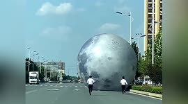 Watch funny moment workers chase after giant moon balloon blown away by strong winds in China