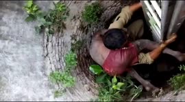 Man carried to safety on rescue worker's shoulders after getting trapped in well