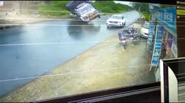 Motorist's lucky escape as large truck overturns next to him