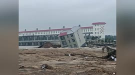 Multi-storey building collapses into river after reservoir discharges floodwater in China