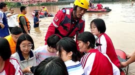 Rescue teams carry stranded students out of submerged high school in China