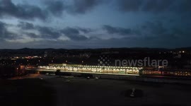 Commuter train passing through the station at night. Night video with nice lights