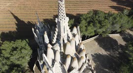Beautiful monastery of Montserrat, with cultivated fields, bells and the blue sky in the background