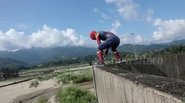 Dressed as Spiderman,this 22 year old stuntman entertains the local crowd with his Unique Parkour skills