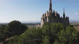 Beautiful monastery of Montserrat, with cultivated fields, bells and the blue sky in the background
