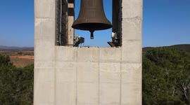Beautiful monastery of Montserrat, with cultivated fields, bells and the blue sky in the background